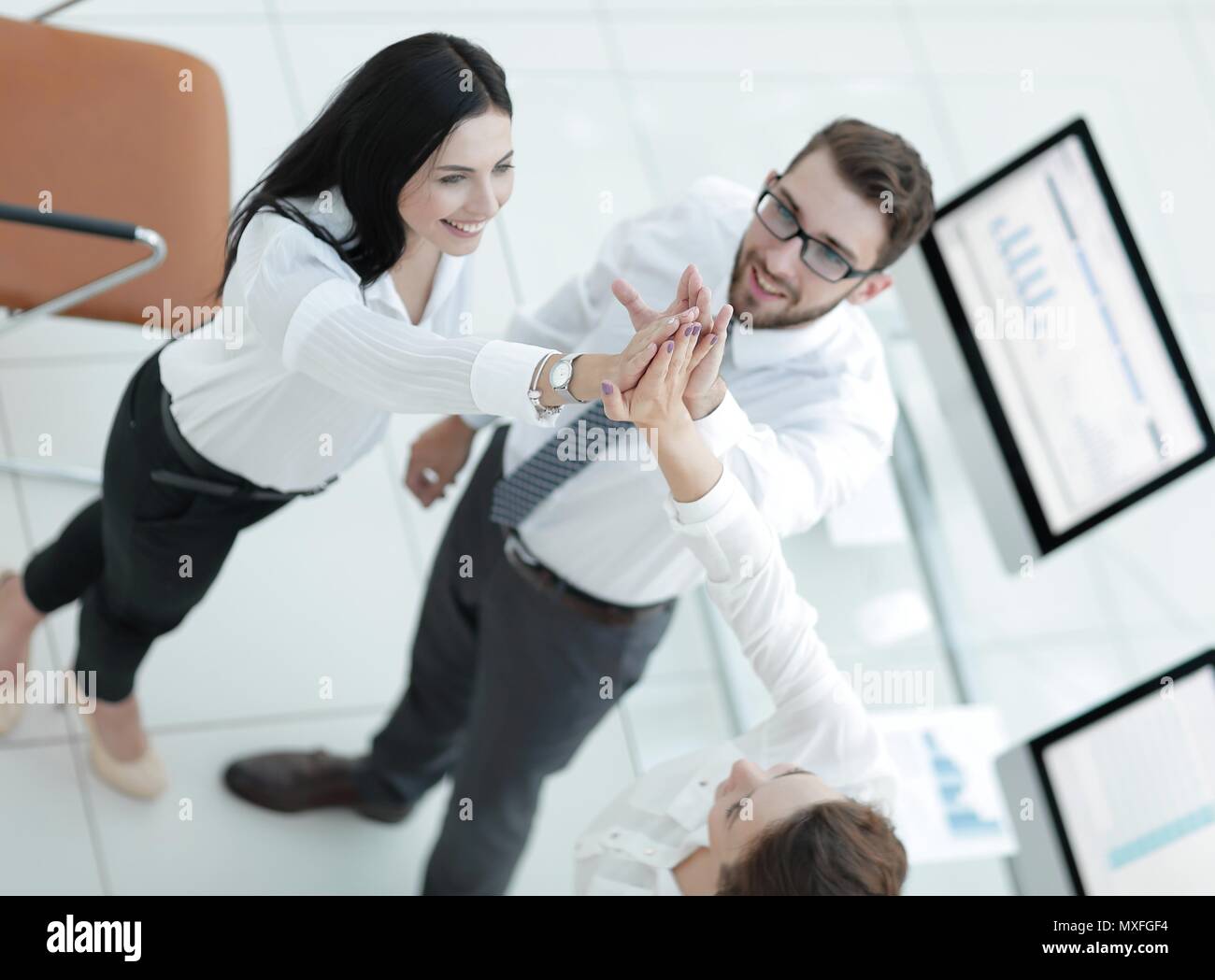 successful business team giving each other a high five Stock Photo - Alamy