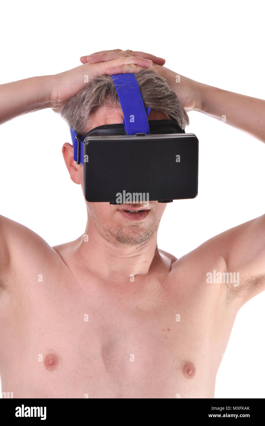 Young bearded topless man playing with visual reality glasses on white background. Stock Photo