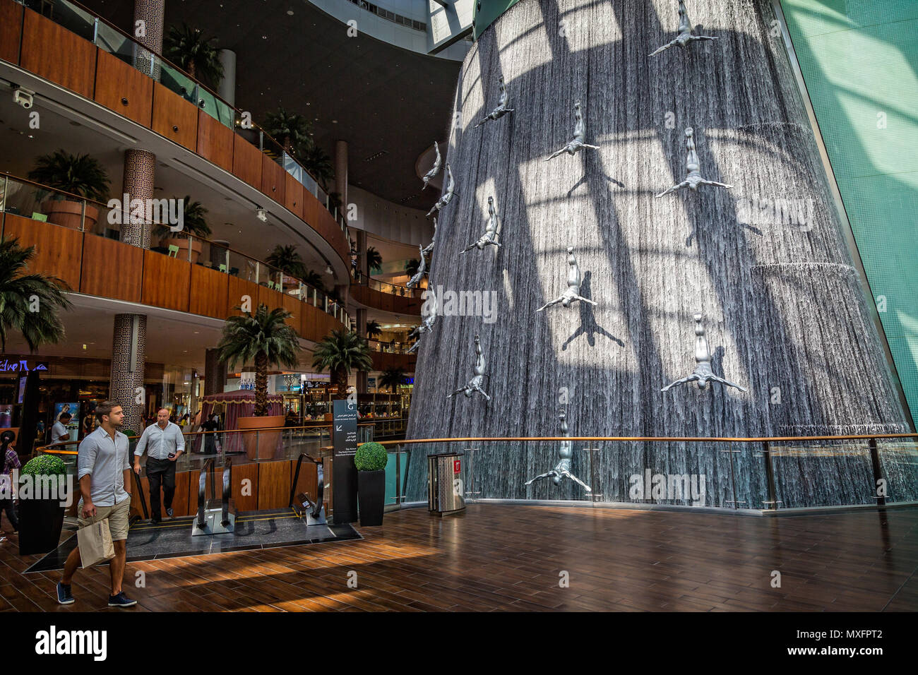 Sculptures of divers diving down a waterfall in The Dubai Mall, Dubai