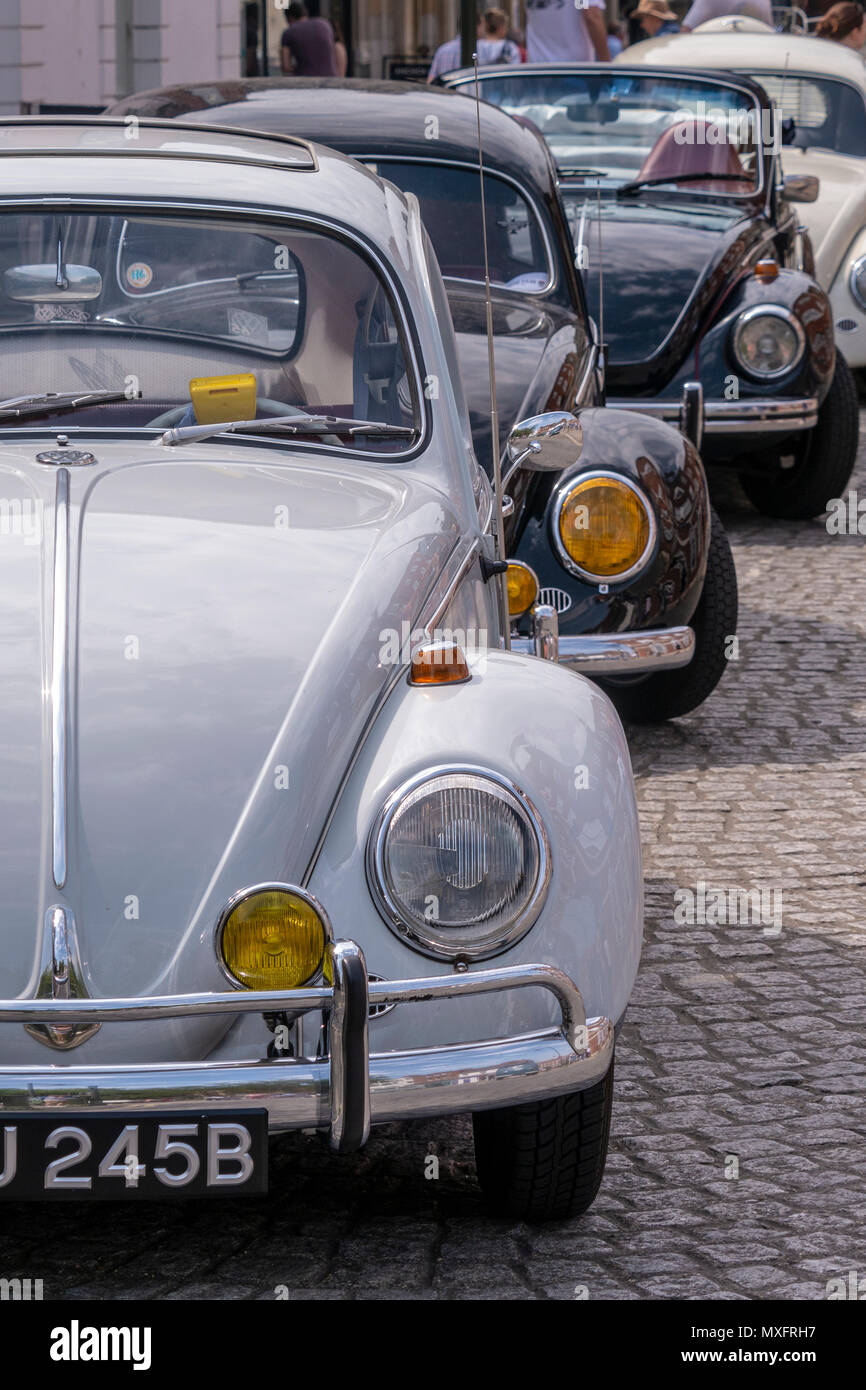 A row of classic VW Beetles - Horsham town centre, West Sussex, UK. Stock Photo