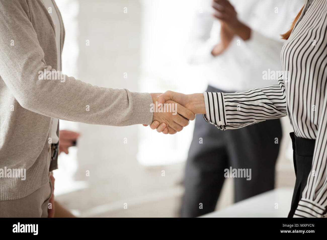 Close up of CEO shaking hand of female employee Stock Photo