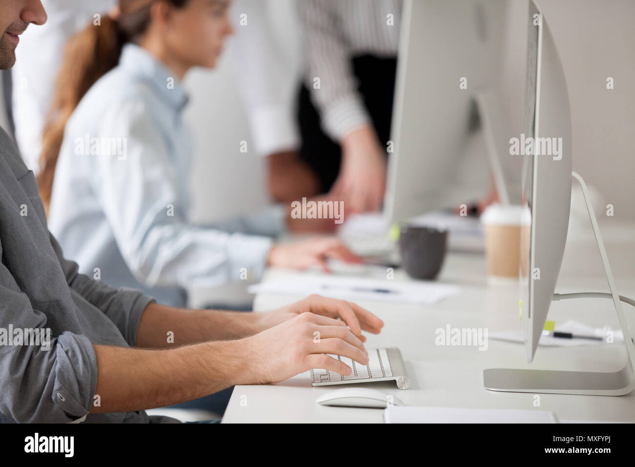 Male employee writing emails to corporate client at computer Stock Photo