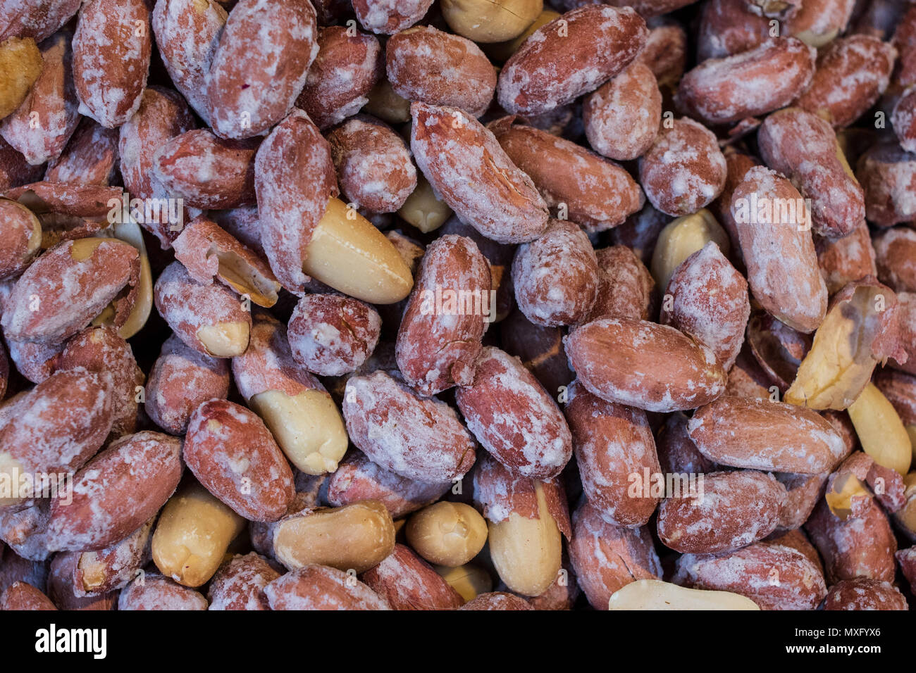 Peanut grains, uncleaned from husks, brown, food background peanuts