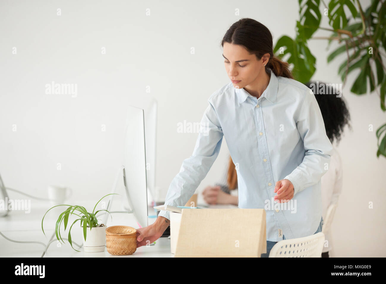 Focused female employee unpacking box with personal belongings Stock ...