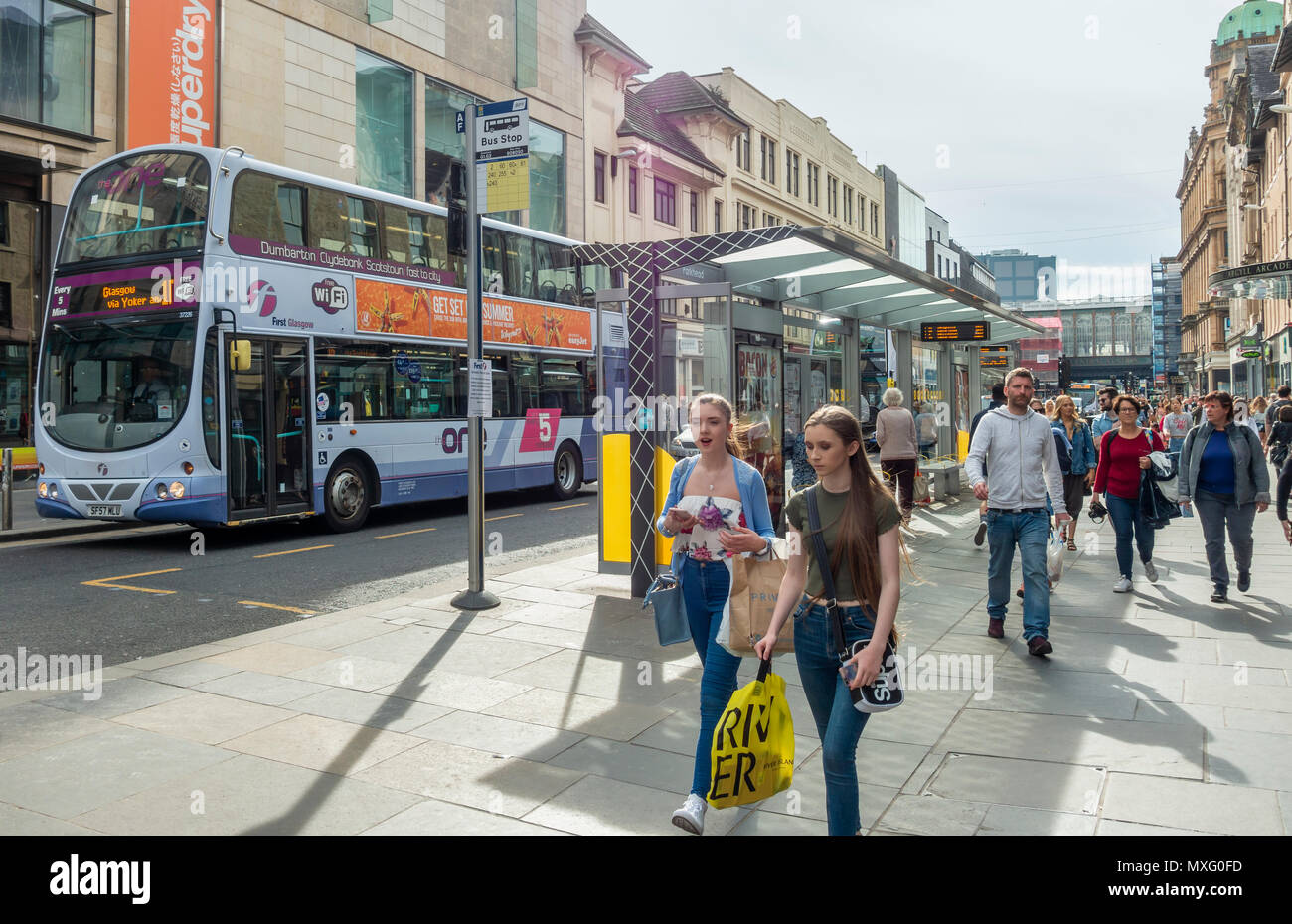 Shoppers and tourists in Argyle Street, Glasgow on a busy afternoon. Bus stops, people, pedestrians, shops, Argyle arcade, Stock Photo