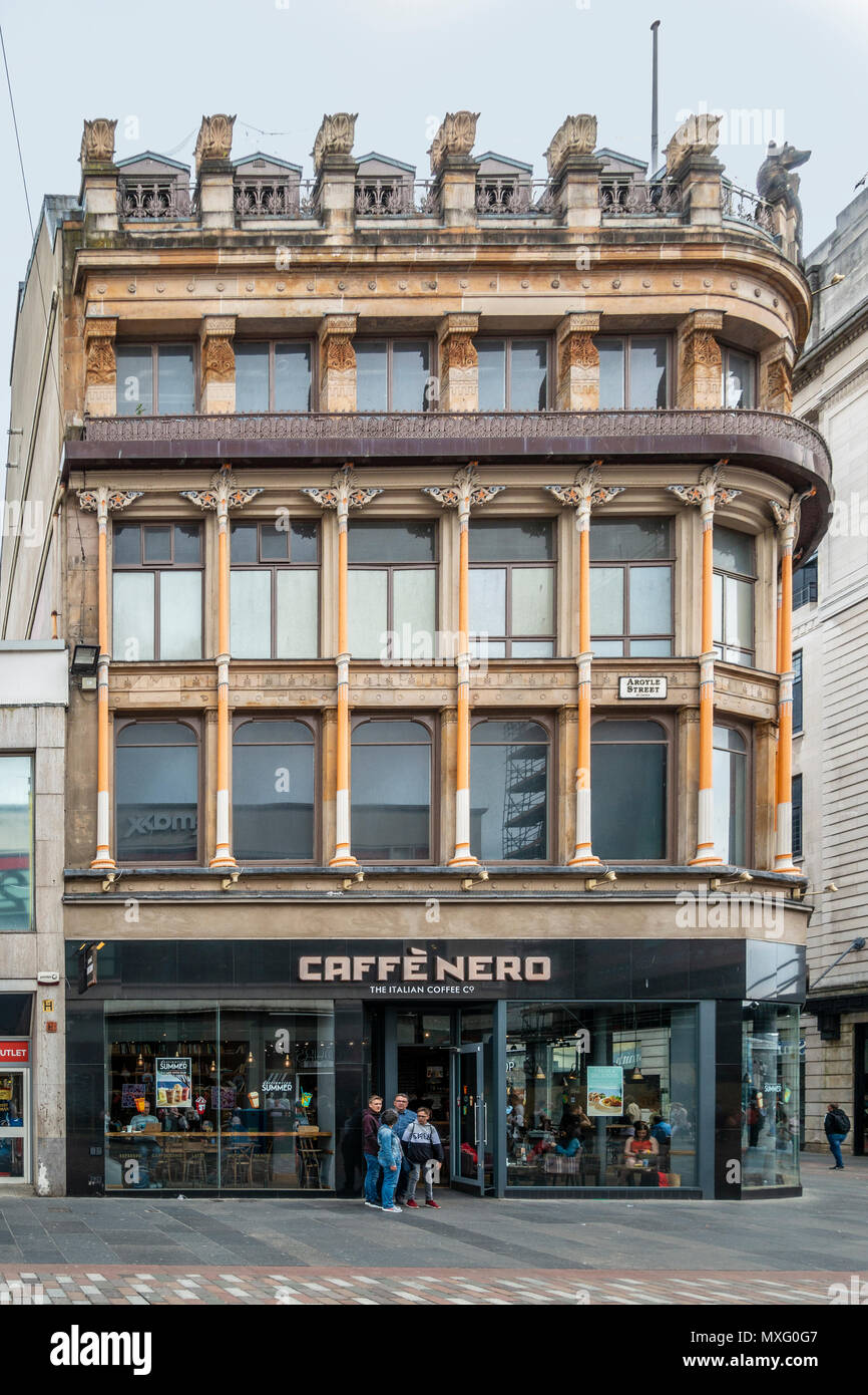 Family standing outside a branch of Caffe Nero in Argyle Street, Glasgow. Customers can be seen inside the windows. Scotland, UK Stock Photo