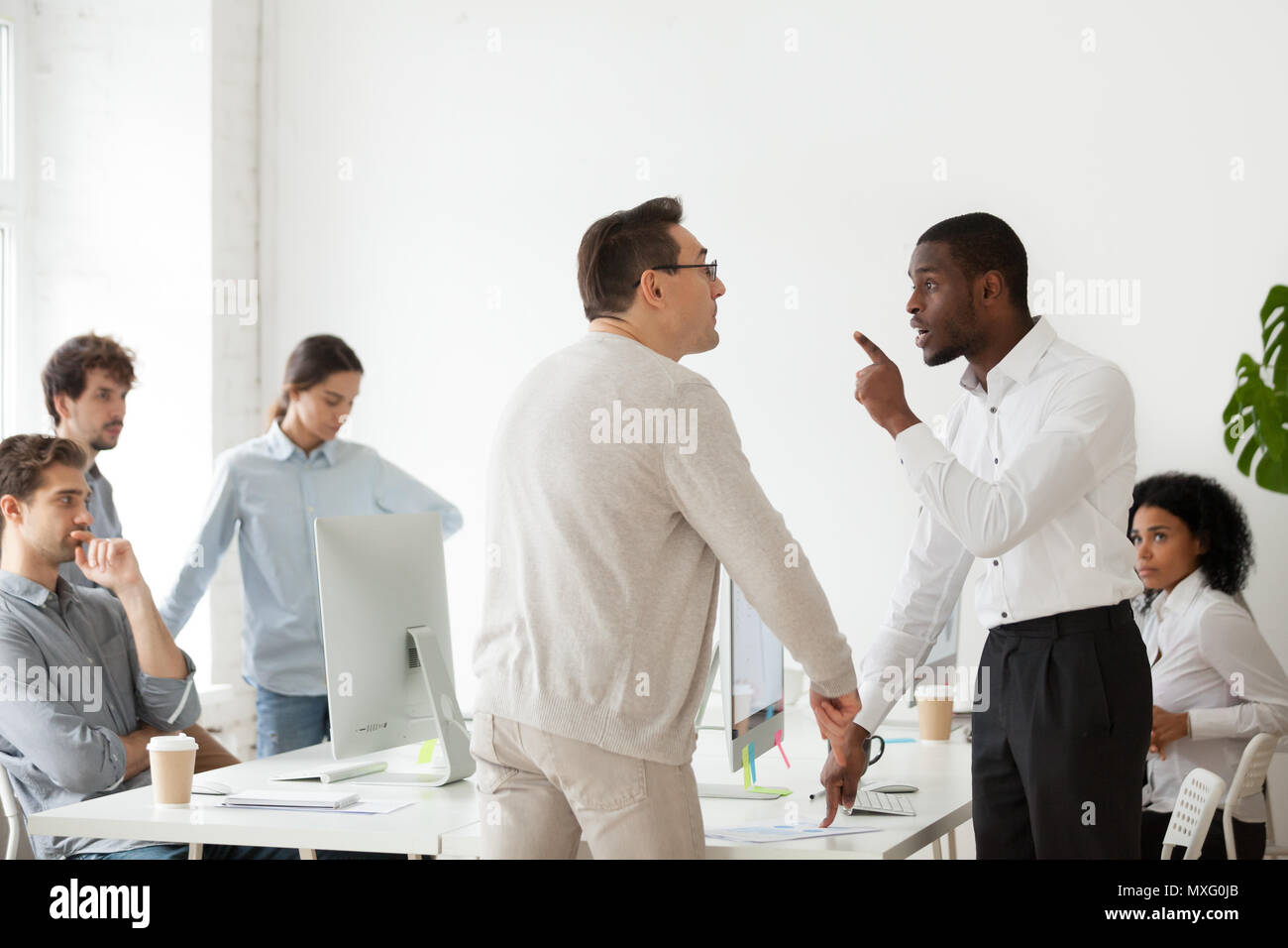Angry black worker disputing with older Caucasian colleague Stock Photo ...