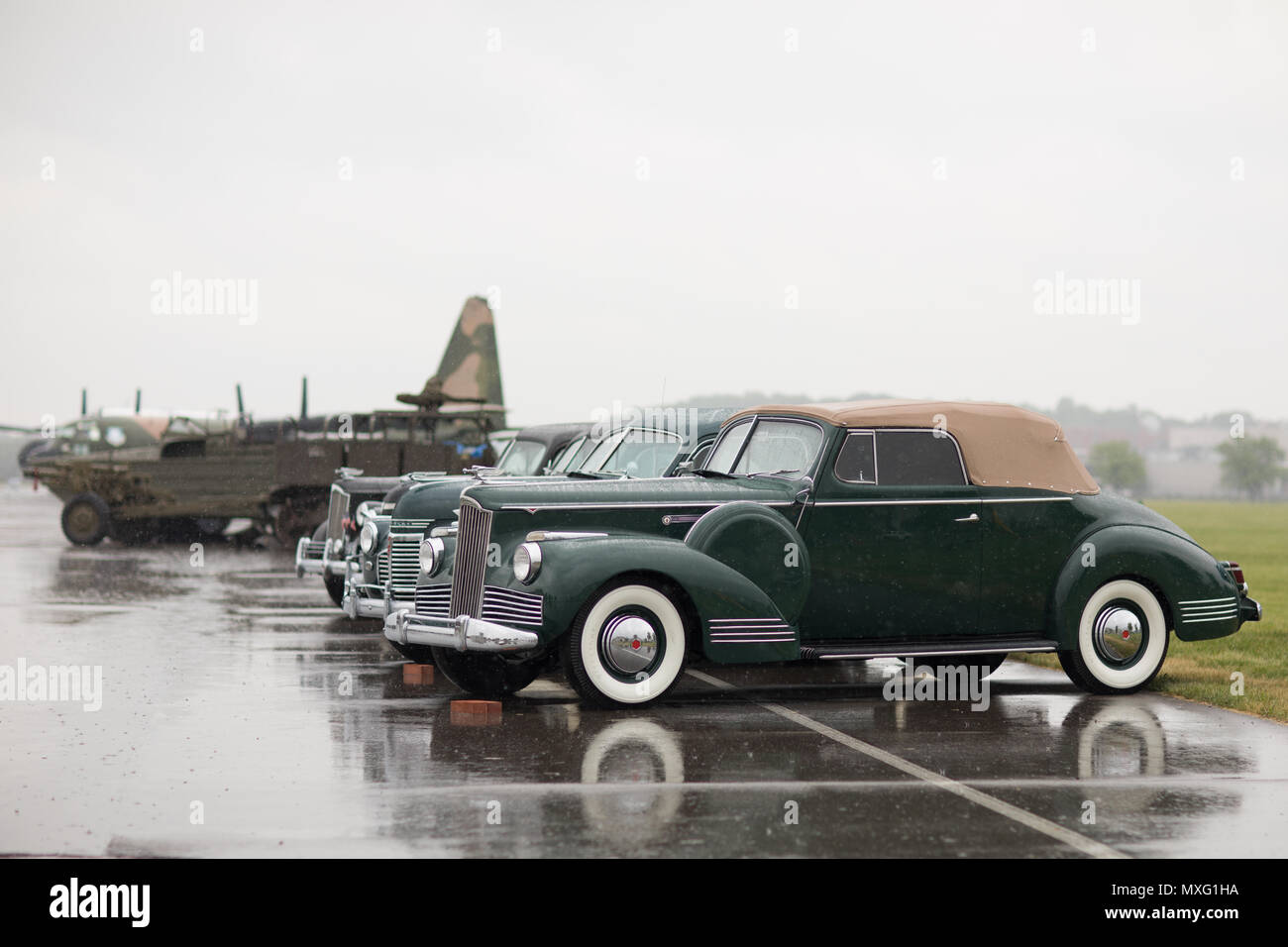 Dayton, Ohio, USA - May 18, 2018 A group of 1940s Packard and other Classic Cars sit in the rain during a ceremony at the National Museum of the USAF. Stock Photo
