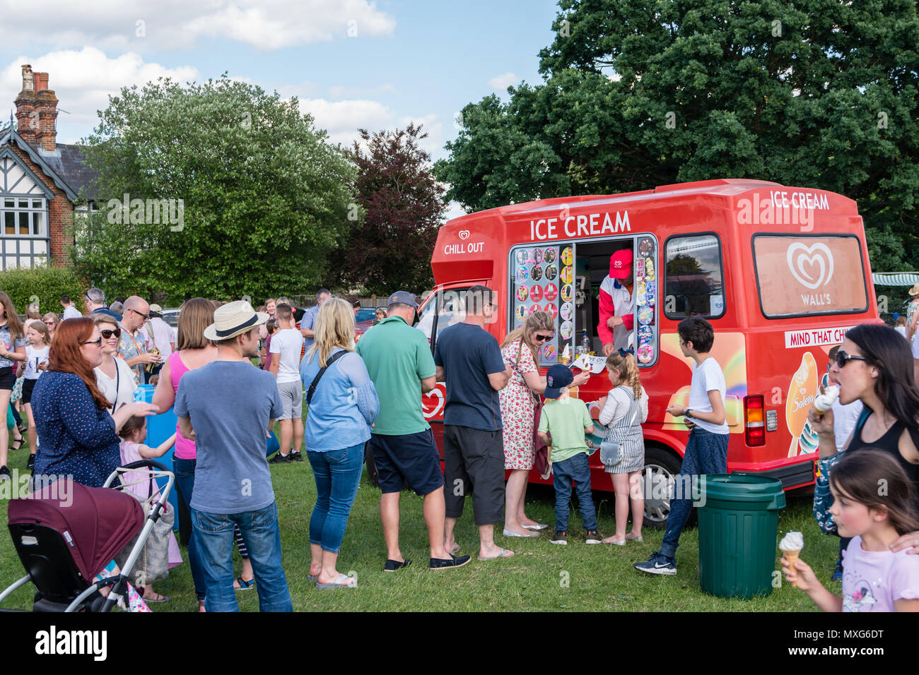 A queue for ice cream being sold from an ice cream van Stock Photo