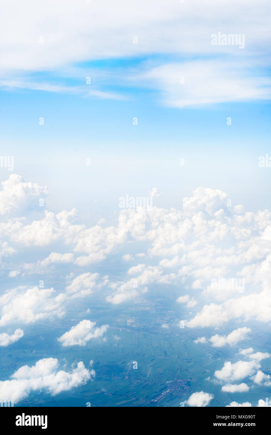 Skyline View above the Clouds from Airplane Window Stock Photo - Alamy