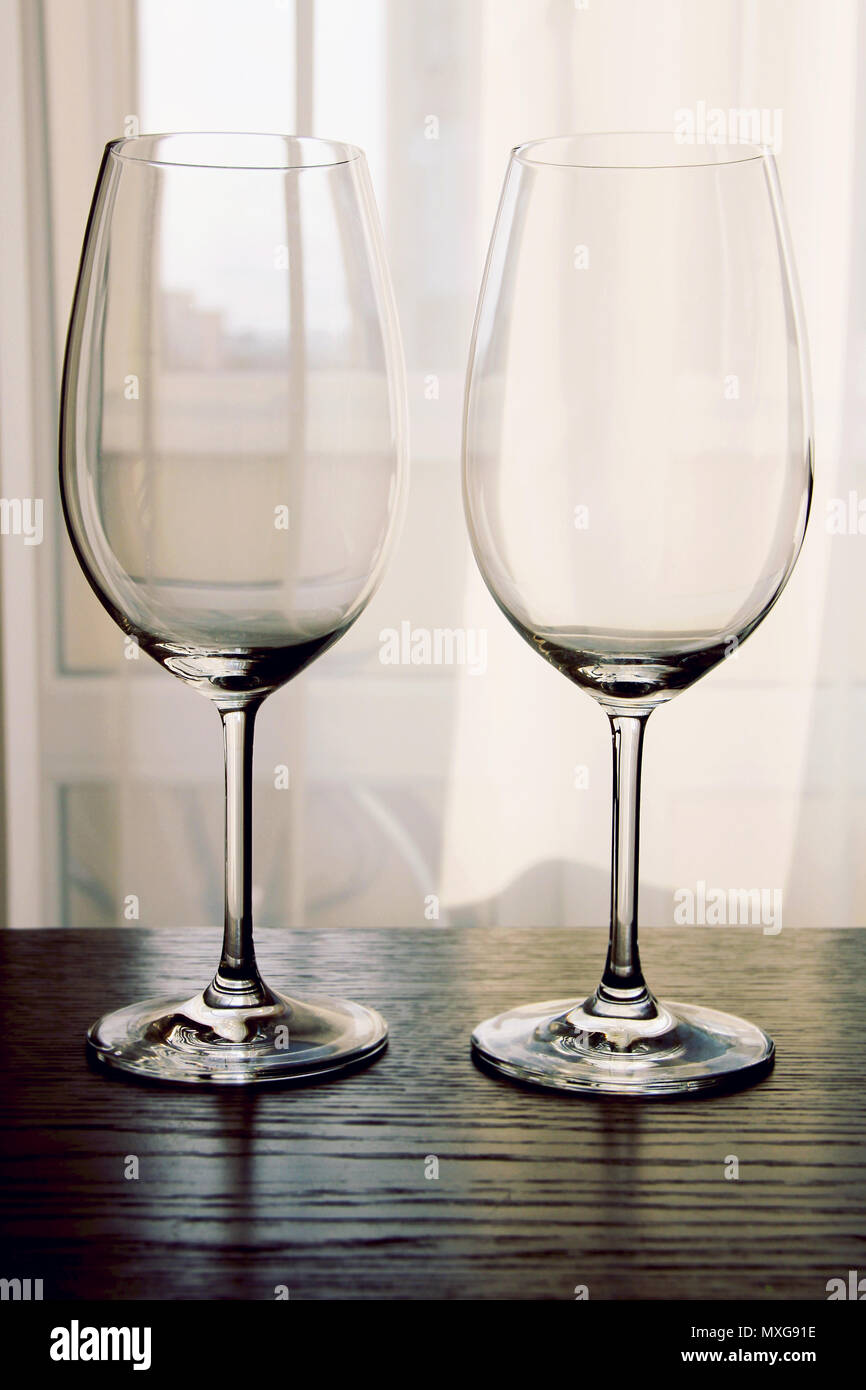 Two empty wine glasses on wooden table close up Stock Photo