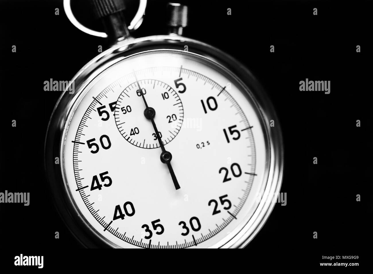 Old stopwatch isolated on wooden background top view. Concept of business time black and white Stock Photo