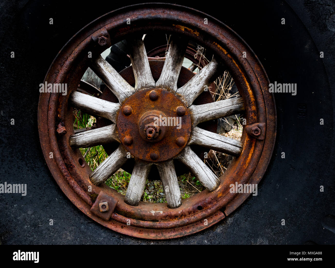 Vintage antique automotive tractor wood wheel spokes close Stock Photo