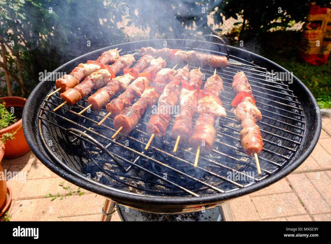 A sunny day in the garden, starting the fire in the grill and then