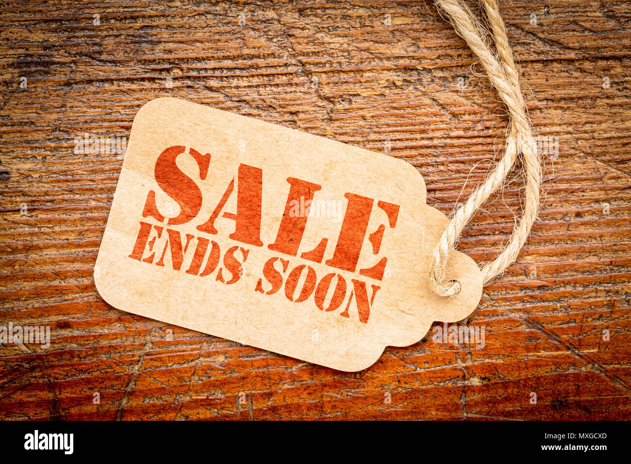 Sale ends soon sign red stencil text on a cardboard price tag against