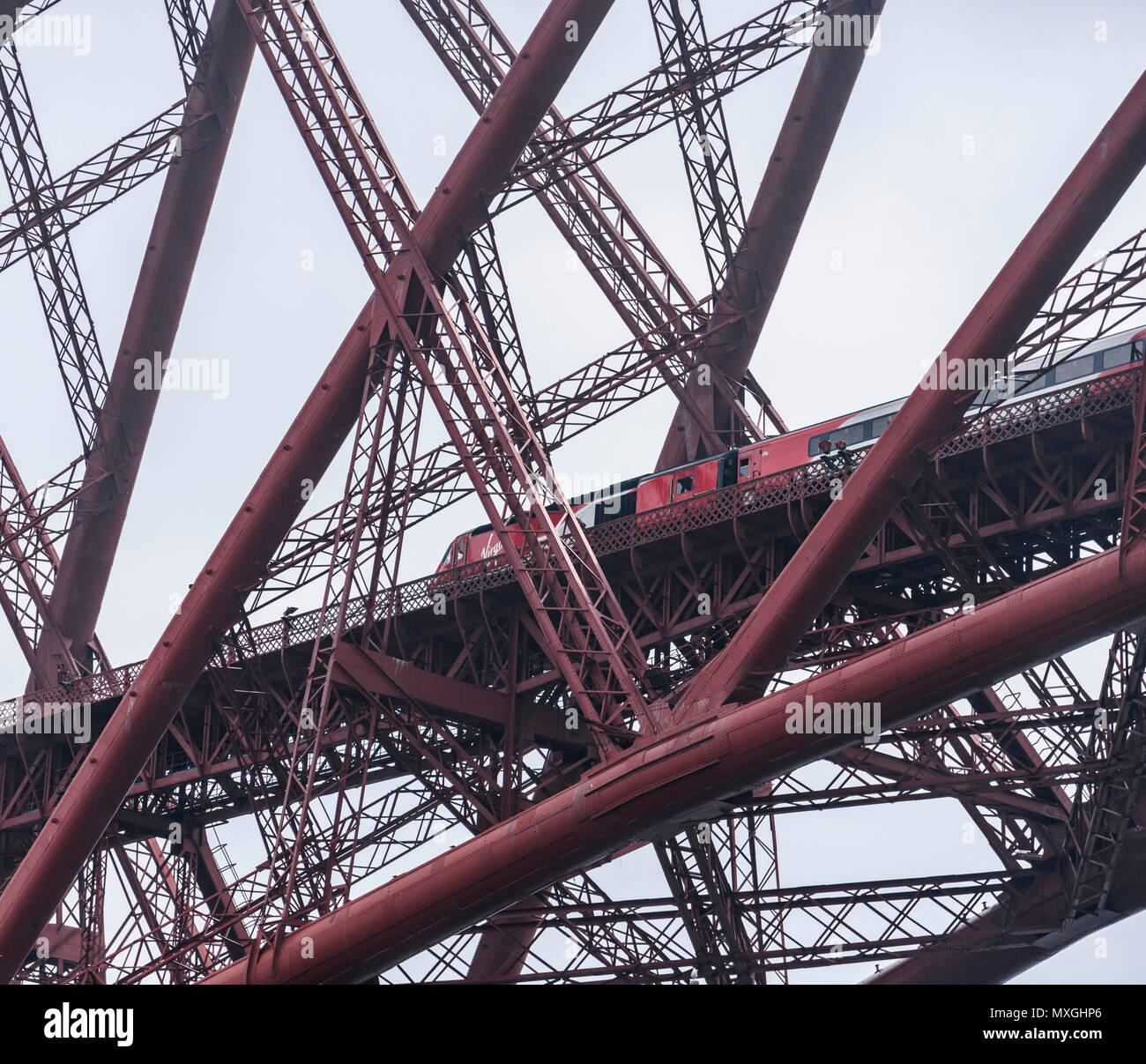 Virgin Trains go south - with the East Coast rail line franchise due to terminate on June 24th, one of the last Virgin trains heads south over the 128-yeat-old Forth Bridge - a study in red, like the Virgin-Stagecoach joint venture's accounts Stock Photo