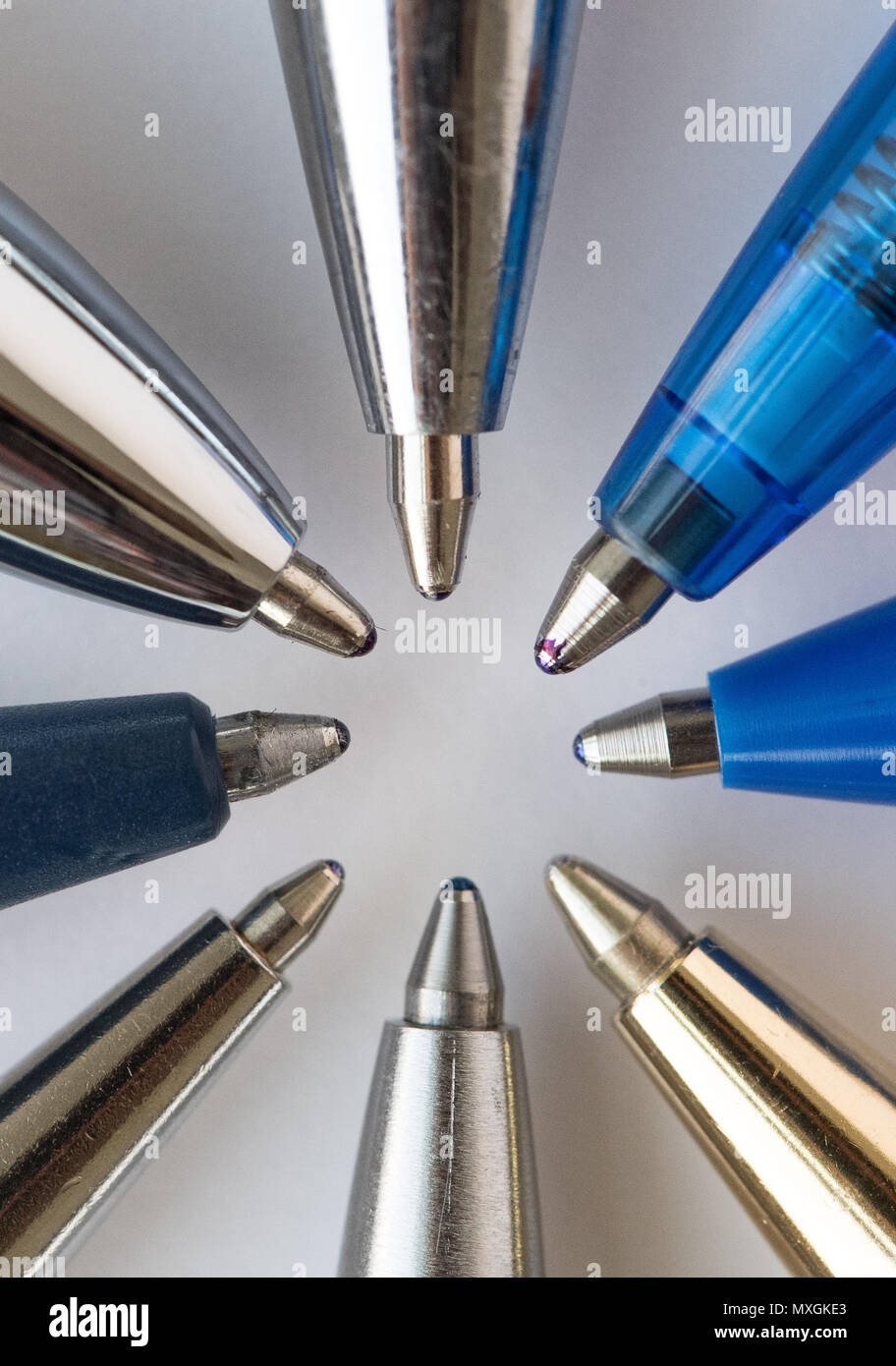 01 June 2018, Germany, Berlin Several ballpoint pens lie on a piece of