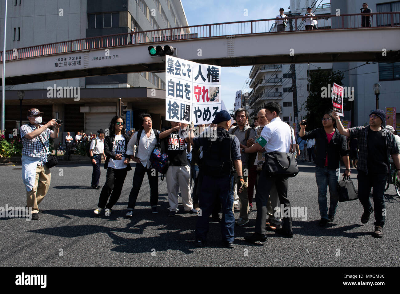 KAWASAKI, JAPAN - JUNE 03: Protesters holding up signs, including one saying 'NO HATE & NO RACISM' gather in front of Educational Cultural Hall in Kawasaki, Kanagawa prefecture, Japan on June 3, 2018. The anti-racist group forcefully stop the nationalists attendees from entering the building for a planned meeting by a hate speech members in Kanto region following a scuffle with the police, nationalists and the protesters. (Photo: Richard Atrero de Guzman/Aflo) Stock Photo