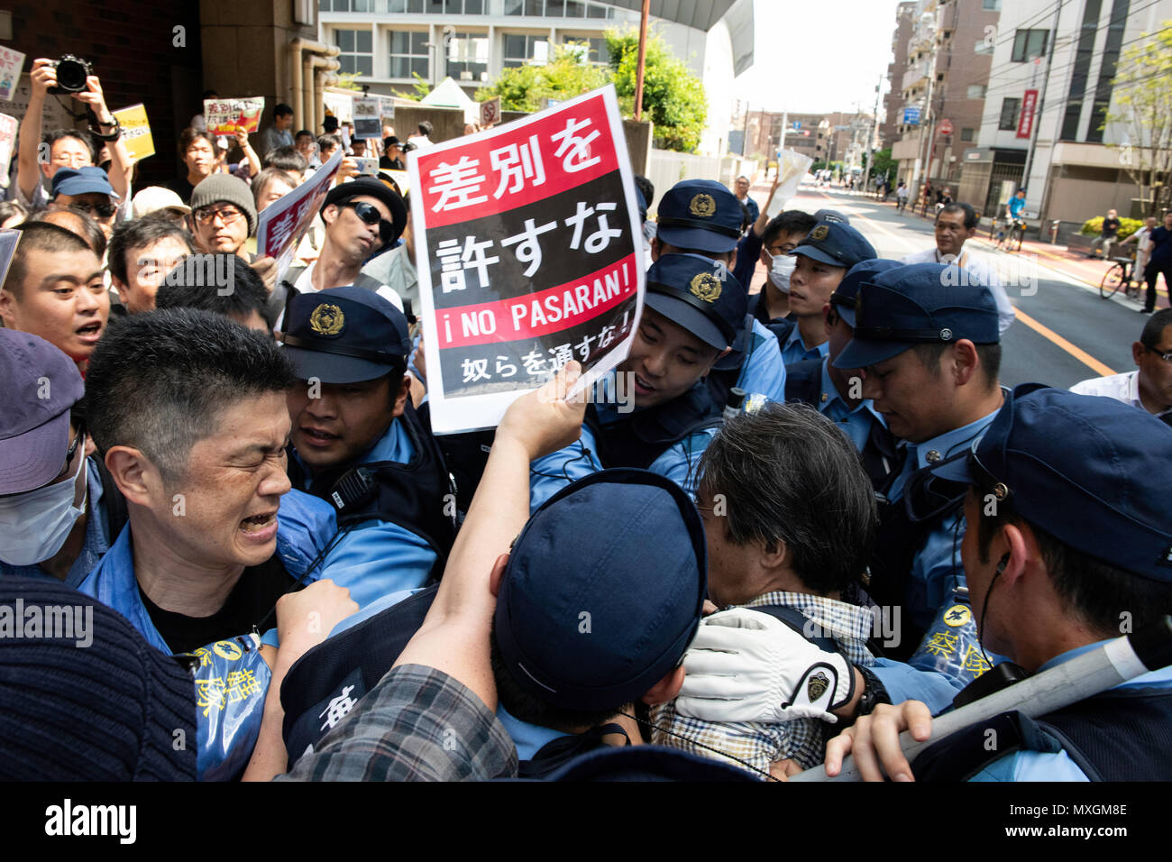 KAWASAKI, JAPAN - JUNE 03: Protesters holding up signs, including one saying 'NO HATE & NO RACISM' gather in front of Educational Cultural Hall in Kawasaki, Kanagawa prefecture, Japan on June 3, 2018. The anti-racist group forcefully stop the nationalists attendees from entering the building for a planned meeting by a hate speech members in Kanto region following a scuffle with the police, nationalists and the protesters. (Photo: Richard Atrero de Guzman/Aflo) Stock Photo
