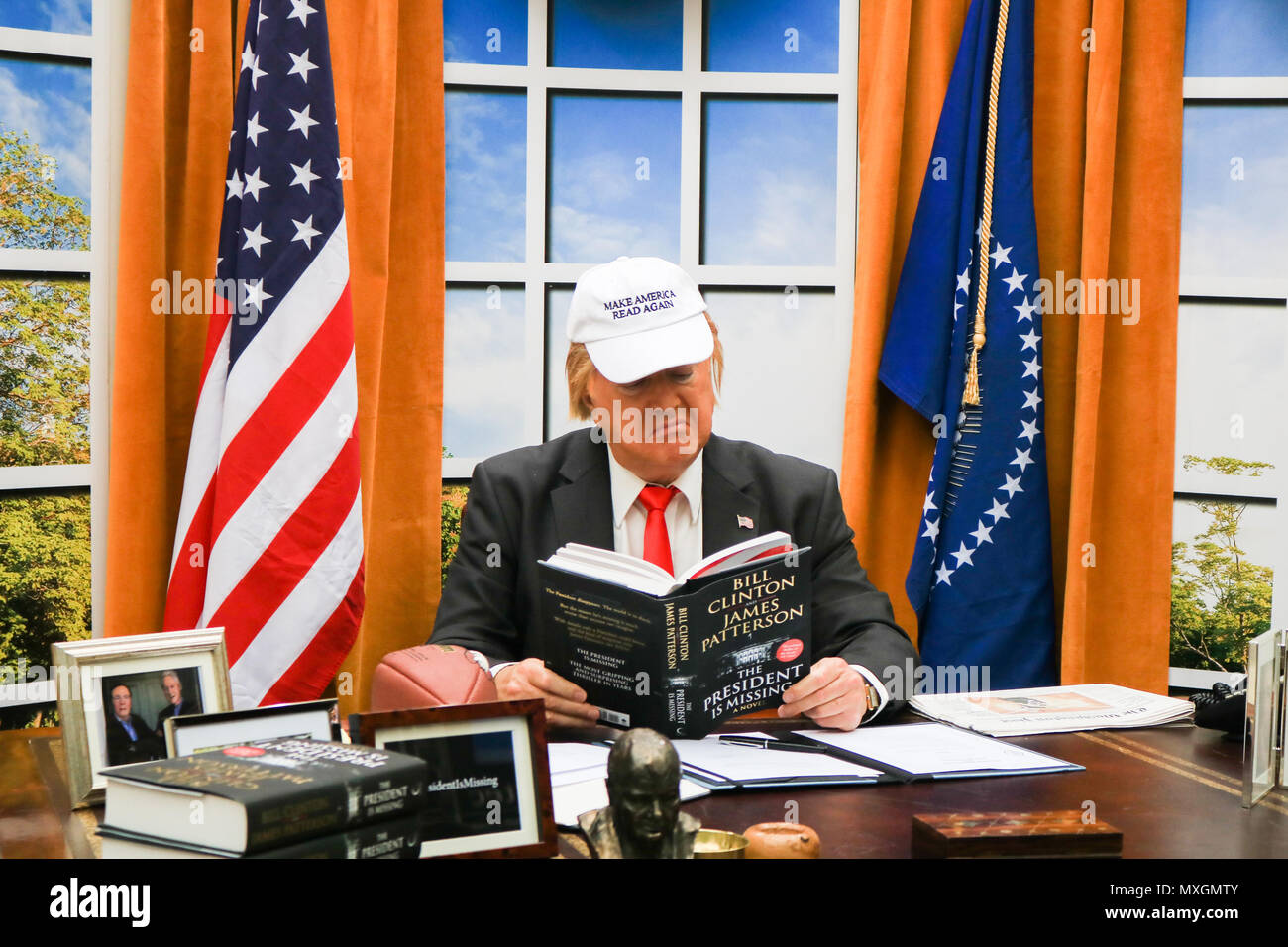 London UK. 4th June 2018. A Donald Trump impersonator sits behind a replica  Oval Office at a book launch at Waterloo Station to promote 'The President is Missing', a novel by Bill Clinton co written with James Patterson Credit: amer ghazzal/Alamy Live News Stock Photo