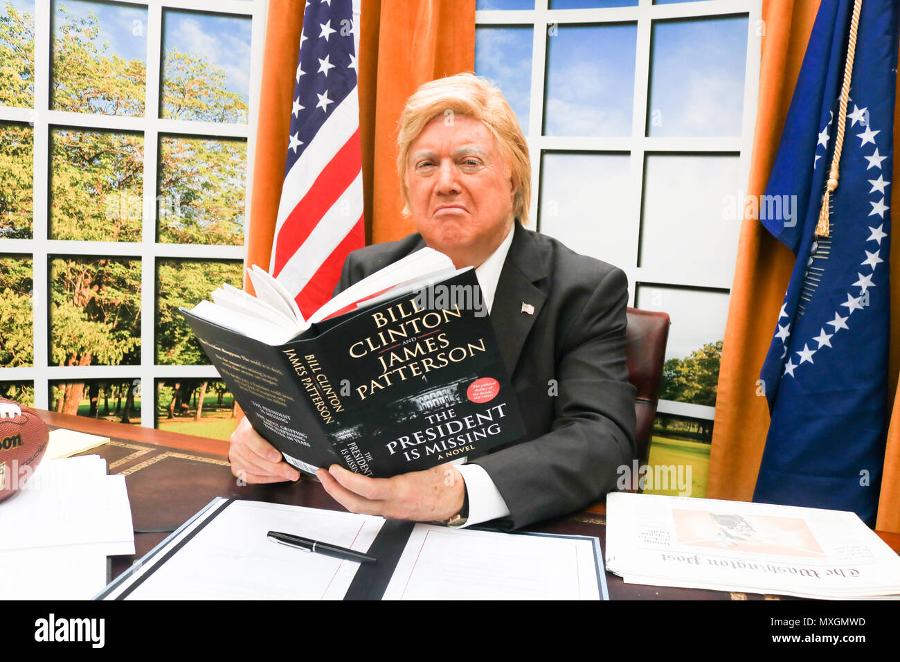 London UK. 4th June 2018. A Donald Trump impersonator sits behind a replica  Oval Office at a book launch at Waterloo Station to promote 'The President is Missing', a novel by Bill Clinton co written with James Patterson Credit: amer ghazzal/Alamy Live News Stock Photo