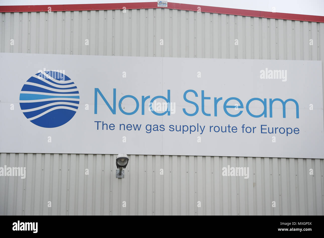 04 June 2018, Germany, Lubmin: The logo of the Nord Stream company on a hall in an industrial area. The project enterprise Nord Stream 2 has taken over responsibility for the contamination of the Bay of Greifswald with lubricants. Around 145 kg of lubricating grease apparently ended up in the bay just before the Pentecost due to a leak in the lubricant system of the dredger 'Peter the Great'. Photo: Stefan Sauer/dpa Stock Photo