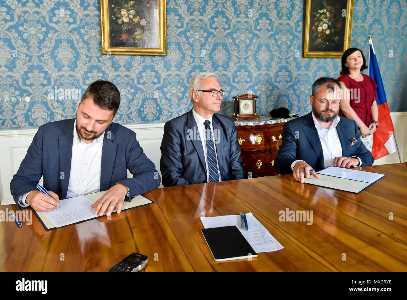 The National Film Archive (NFA) and the Film and Television School of the Academy of Performing Art (FAMU) in Prague made an agreement on the digitisation of Czech films today, on Monday, June 4, 2018. The agreement, signed by FAMU Dean Zdenek Holy, left, and NFA director Michal Bregant, right, guarantees that the digital restoration would be carried out in cooperation with the living film-makers, primarily the director, photographer and sound mixer, that their testimonies and expert opinions will be recorded. On the photo centre there is Culture Minister Ilja Smid. (CTK Photo/Vit Simanek) Stock Photo