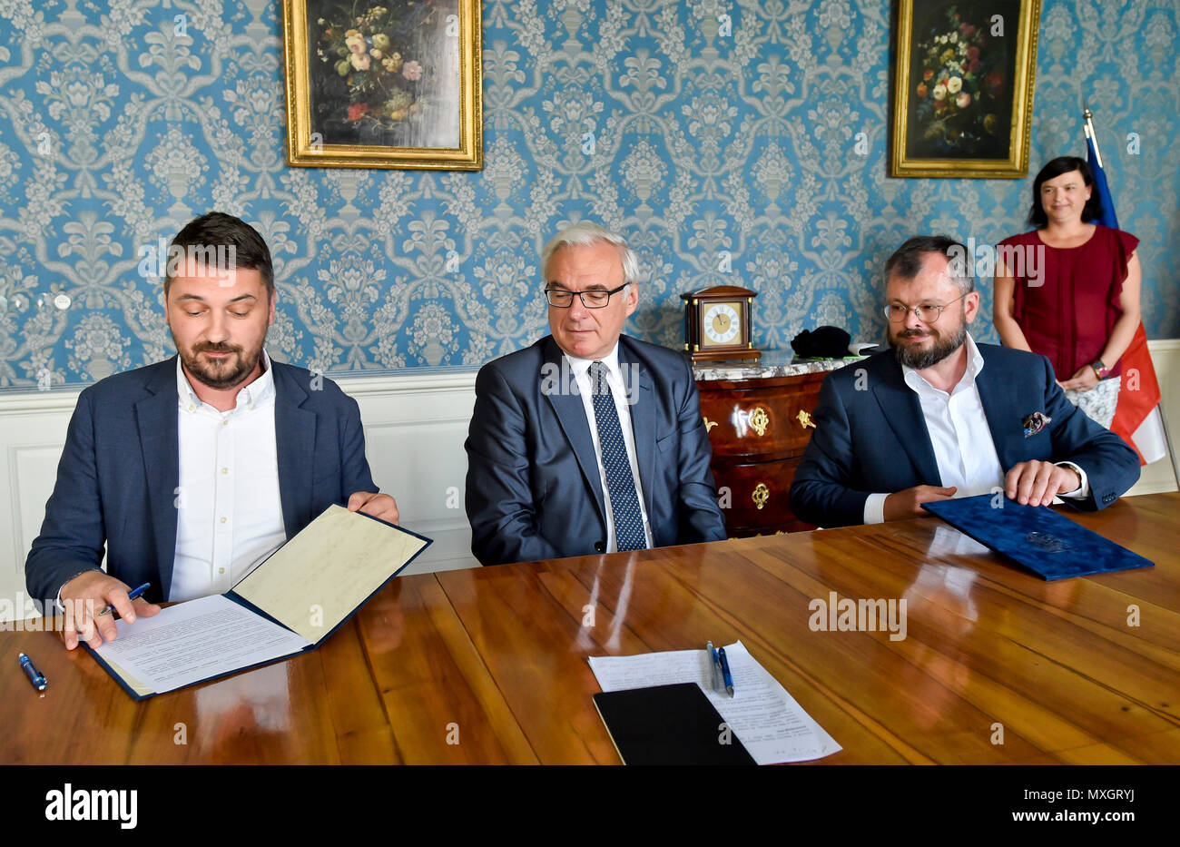 The National Film Archive (NFA) and the Film and Television School of the Academy of Performing Art (FAMU) in Prague made an agreement on the digitisation of Czech films today, on Monday, June 4, 2018. The agreement, signed by FAMU Dean Zdenek Holy, left, and NFA director Michal Bregant, right, guarantees that the digital restoration would be carried out in cooperation with the living film-makers, primarily the director, photographer and sound mixer, that their testimonies and expert opinions will be recorded. On the photo centre there is Culture Minister Ilja Smid. (CTK Photo/Vit Simanek) Stock Photo