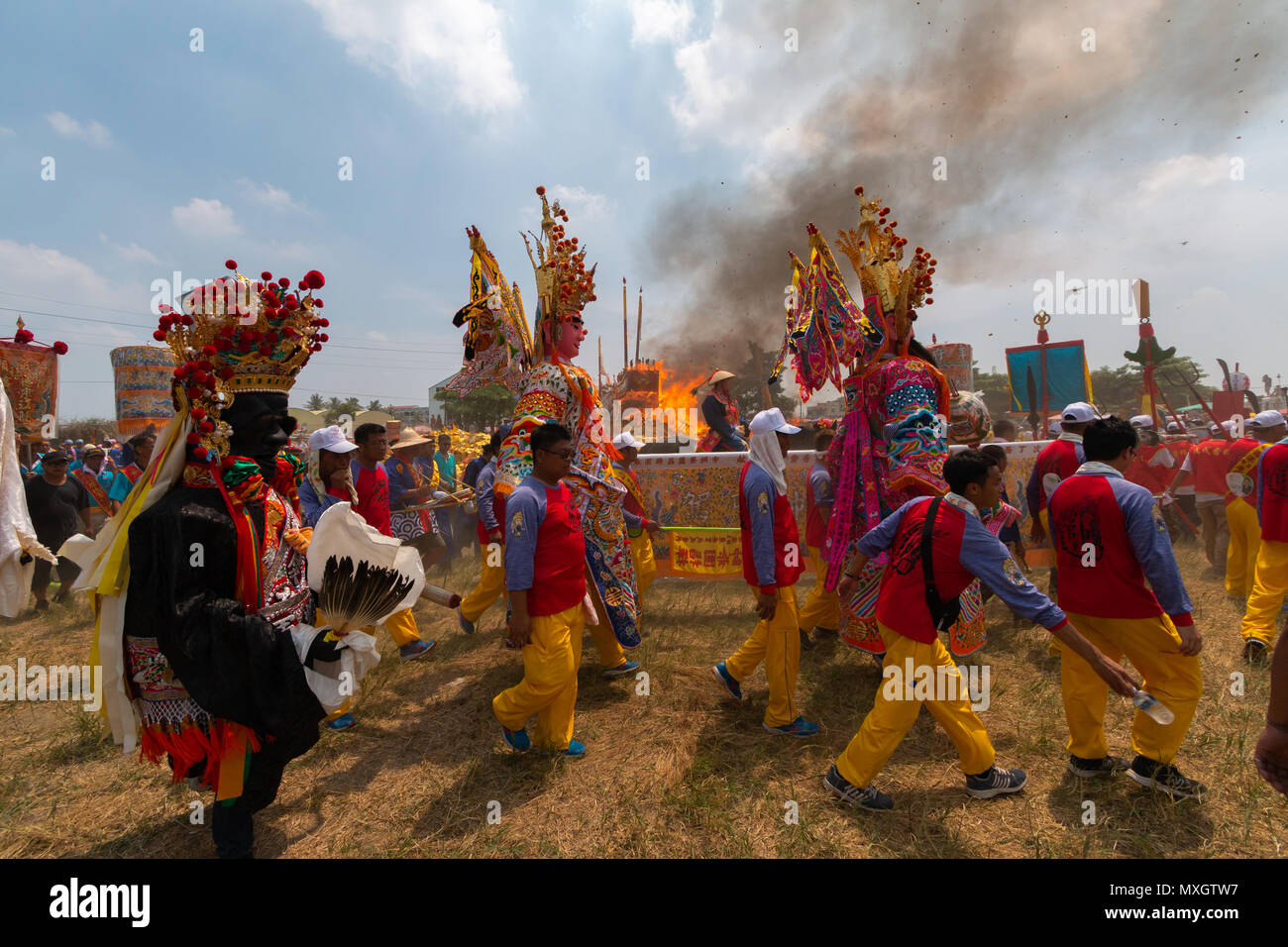 Xigang, Taiwan, 4 June, 2018: Members of temple associations from across Taiwan march past the King Boat as it is being burned in a three-yearly daoist ritual to cleanse the area of Xigang in southern Taiwan from pestilence and bad spirits that ends with the burning of the boat. Credit: Perry Svensson/Alamy Live News Stock Photo