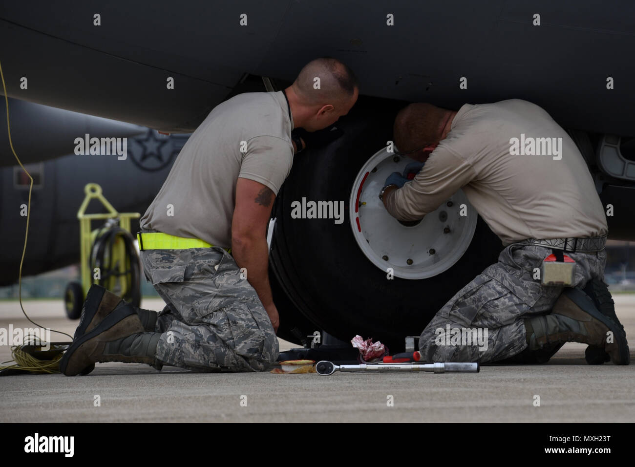 Master Sgt. Zac Michalski and Tech. Sgt. Mark Dulworth change a tire of a C-130H Hercules on the flightline Nov. 2, 2016, at the 179th Airlift Wing, Mansfield, Ohio. The Ohio Air National Guard unit is always on mission to respond with highly qualified citizen airmen to execute Federal, State and community missions. (U.S. Air National Guard photo by Airman Megan ShepherdReleased) Stock Photo