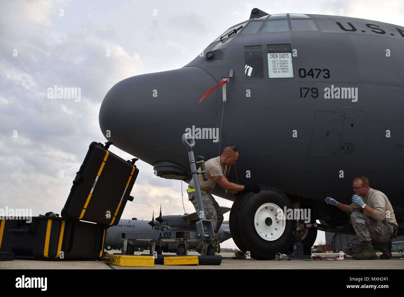 Master Sgt. Zac Michalski and Tech. Sgt. Mark Dulworth change a tire of a C-130H Hercules on the flightline Nov. 2, 2016, at the 179th Airlift Wing, Mansfield, Ohio. The Ohio Air National Guard unit is always on mission to respond with highly qualified citizen airmen to execute Federal, State and community missions. (U.S. Air National Guard photo by Airman Megan ShepherdReleased) Stock Photo
