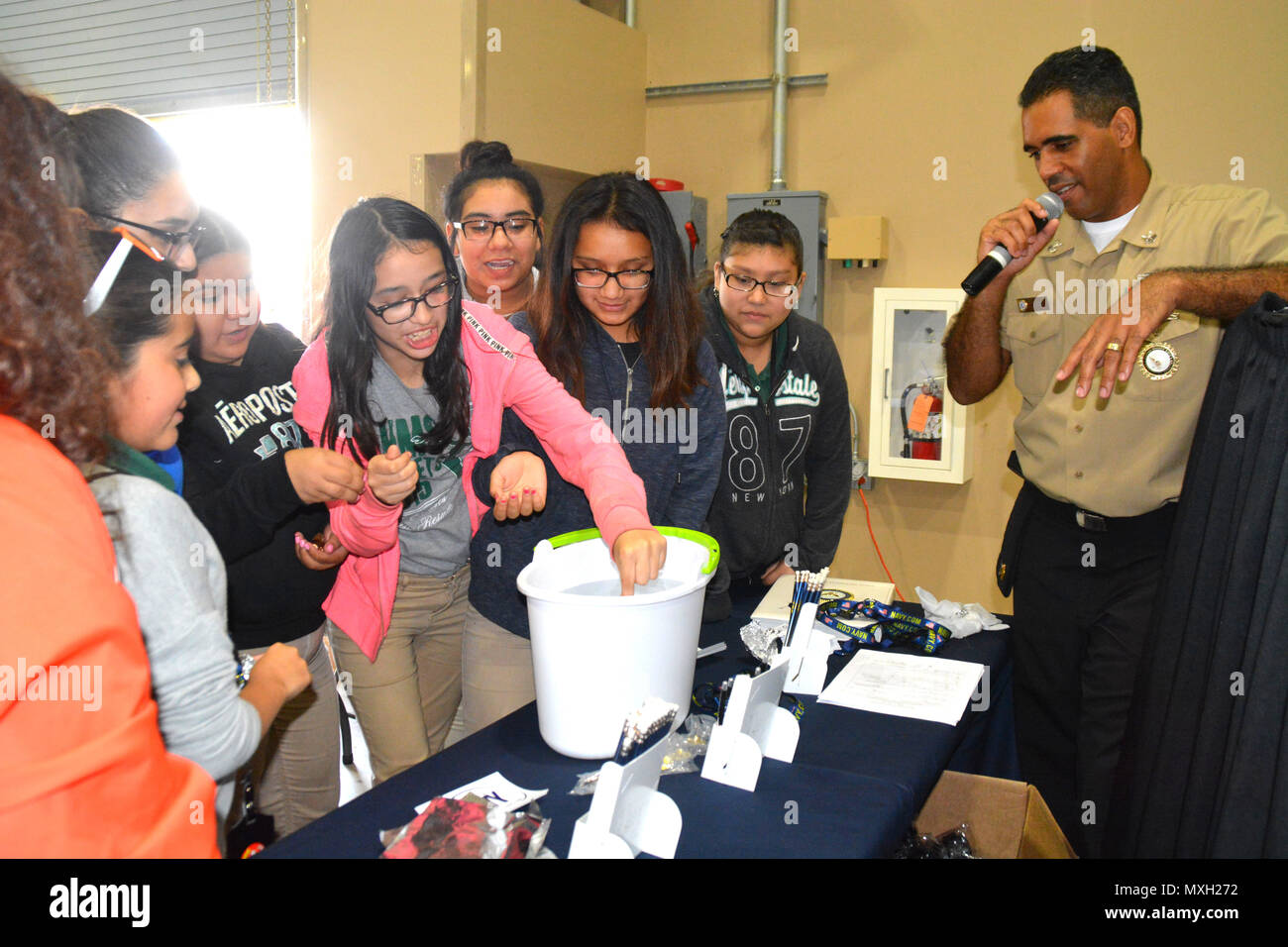 SAN ANTONIO - (Nov. 1, 2016) Harlem, N.Y. native, Petty Officer 1st Class Daniel Jimenez, a recruiter assigned to Navy Recruiting Station Ingram, Navy Recruiting District San Antonio, instructs middle school girls on the Penny Boat Challenge during the Hispanic Chamber of Commerce's CORE4 STEM Expo held at the Freeman Expo Hall.  Jimenez is a 1999 graduate of A. Philip Randolph High School in New York.  The expo, consisting an all-female day and all-male day, featured leaders from the energy, science, computer, and aerospace industries and presented students with the opportunity to meet with h Stock Photo