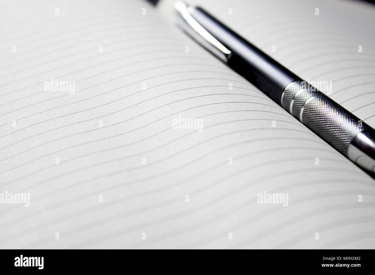Pen laying over notebook Stock Photo