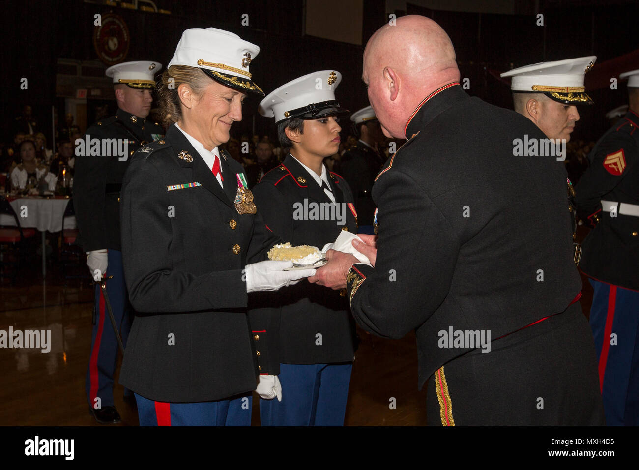 U.S. Marine Corps Maj. Gen. Walter L. Miller, Jr., commanding general of II Marine Expeditionary Force (II MEF), right, presents a slice of cake to Col. Robin A. Gallant, oldest Marine at the II MEF Marine Corps Birthday Ball at Marine Corps Base Camp Lejeune, N.C., Nov. 5, 2016. Commandant of the Marine Corps Gen. Robert B. Neller attended the birthday ball as the guest of honor. (U.S. Marine Corps photo by Cpl. Samantha K. Braun) Stock Photo