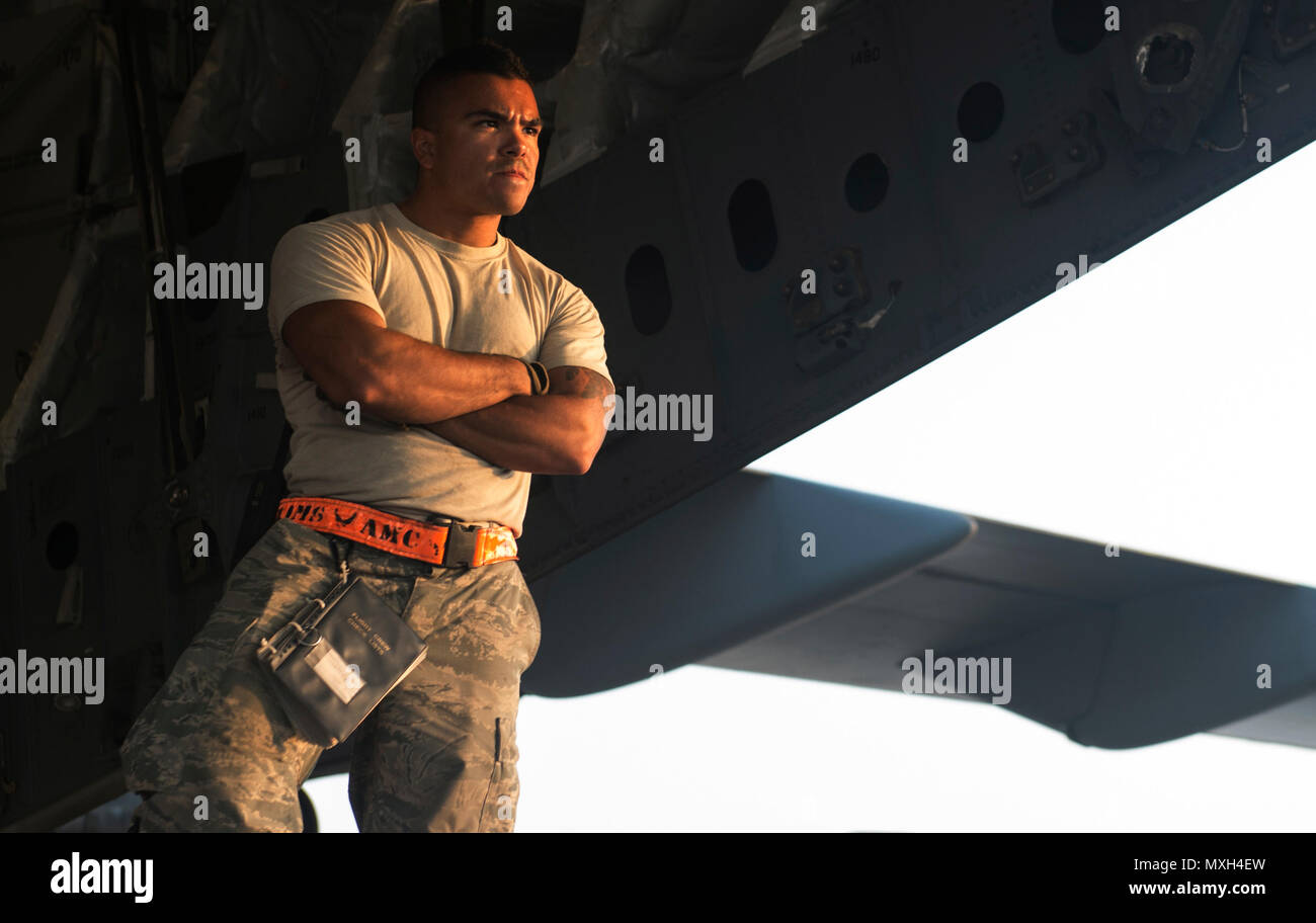 Senior Airman Zephaniah Valdez, 8th Expeditionary Air Mobility Squadron ramp transportation journeyman, watches a K-loader bearing pallets approach for loading into an 816th Expeditionary Airlift Squadron C-17 Globemaster III in support of Operation Freedom’s Sentinel Nov. 3, 2016. The operation focuses on training, advising, and assisting the Afghan Security Institutions and Afghan National Defense and Security Forces in order to build their capabilities and long-term sustainability. (U.S. Air Force photo by Staff Sgt. Matthew B. Fredericks) Stock Photo