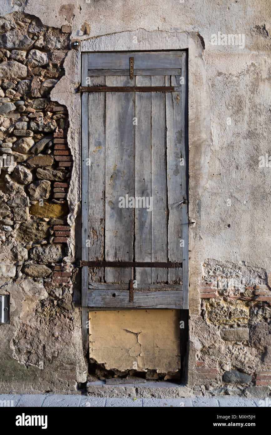 Texture of old damaged stone wall with closed wooden shutters Stock ...