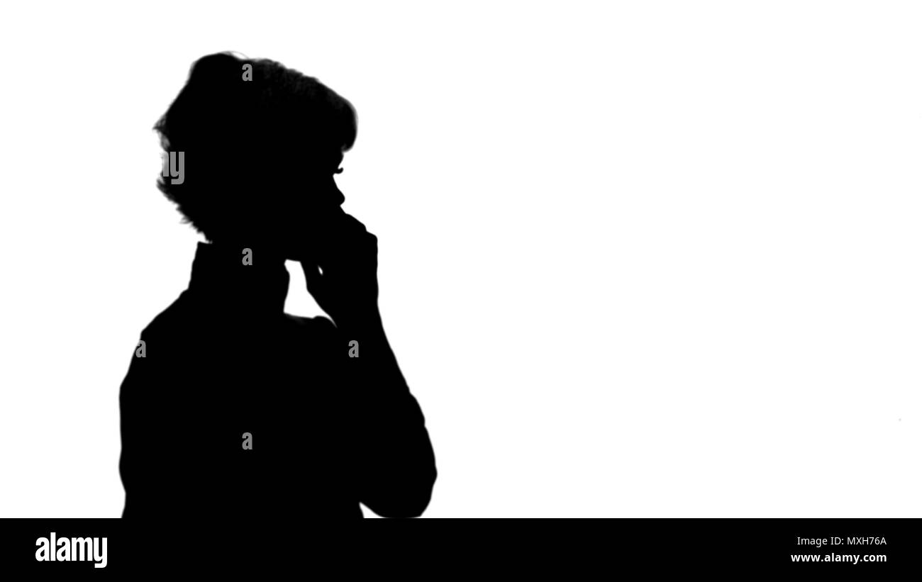 Silhouette Happy businesswoman speaking at the phone track matte Stock Photo