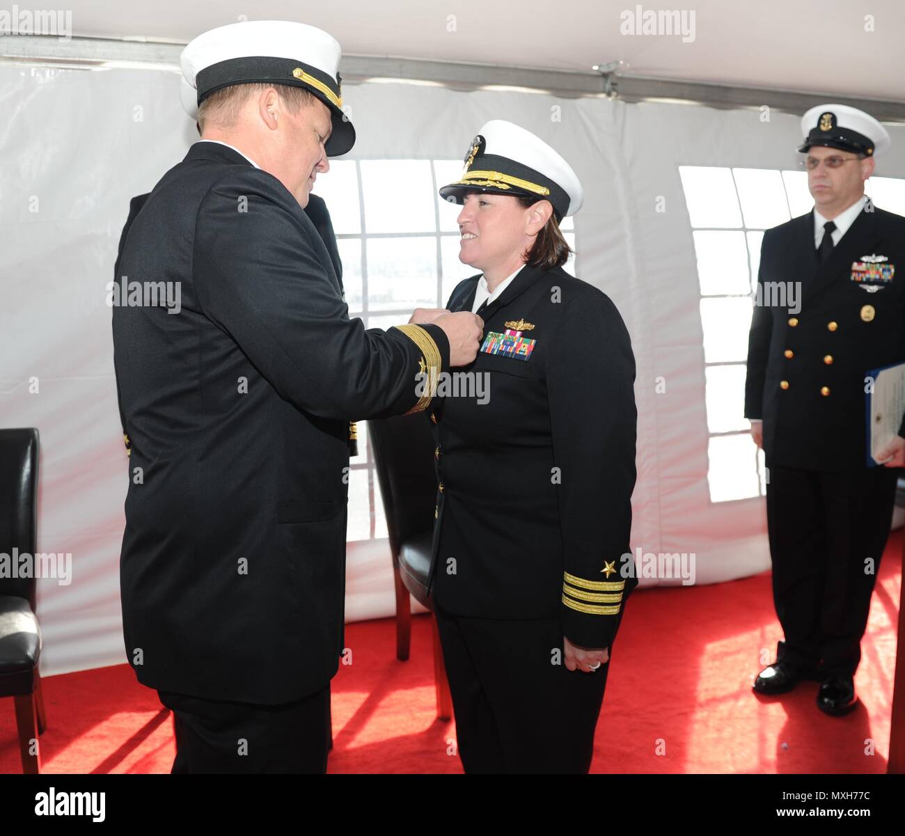 161104-N-MV682-002 NORFOLK (Nov. 4, 2016) Capt. Larry Legree, left, Commander, Amphibious Squadron EIGHT (PHIBRON 8) awards Cmdr. Tina Dalmau a Meritorious Service Medal during a change of command ceremony for dock landing ship USS Carter Hall (LSD 50) held on Joint Expeditionary Base Little Creek-Fort Story. (U.S. Navy photo by Mass Communication Specialist 2nd Class Jamie V. Cosby/Released) Stock Photo