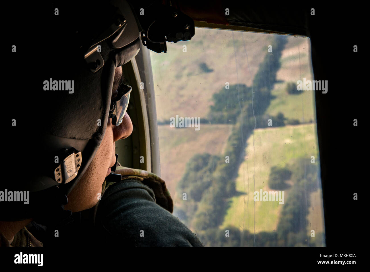 Staff Sgt. Edgar Elizalde, 71st Rescue Squadron loadmaster, looks out ...