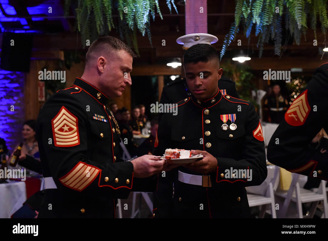 161104-N-OO032-200 POULSBO, Wash. (Nov. 4, 2016) Marine Corps Security Force Battalion-Bangor Command Sgt. Maj. David McKinley, the oldest Marine in attendance, shares a piece of cake with Pfc. Christian Pichardo, the youngest Marine in attendance, during the 241st United States Marine Corps birthday ball hosted by the battalion at the Kiana Lodge. Maj. Gen. John Lejeune issued General Order 47 on November 1, 1921, for Marines to commemorate the establishment of the Continental Marines — November 10, 1775. (U.S. Navy photo by Petty Officer 1st Class Cory Asato/Released) Stock Photo