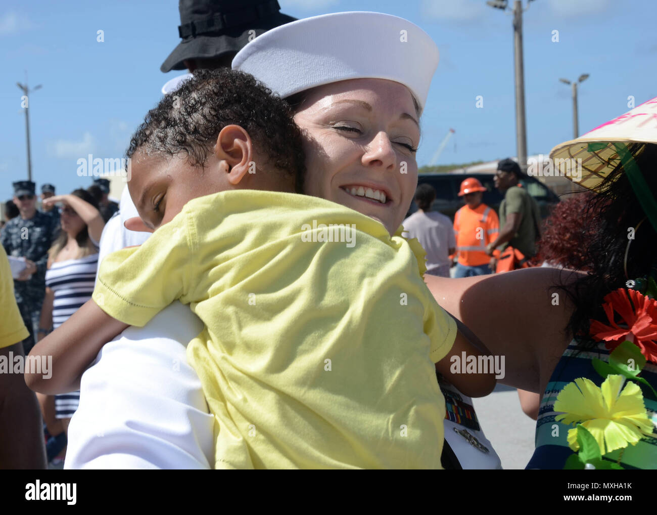 161108-N-WA347-113 SANTA RITA, Guam (Nov. 8, 2016) – Petty Officer 2nd Class Sarah Martindale, native of Owensboro, Ky., assigned to the submarine tender USS Frank Cable (AS 40), is reunited with her son on the pier at Naval Base Guam after completing a five-month deployment, Nov. 8.  Frank Cable departed Guam June 6, was a persistent presence throughout the Indo-Asia-Pacific region during its deployment providing vital flexibility to the fleet commanders, extending the range and impact of U.S. naval forces in the U.S. Navy’s 5th and 7th Fleets.  Forward deployed to Guam, Frank Cable’s combine Stock Photo