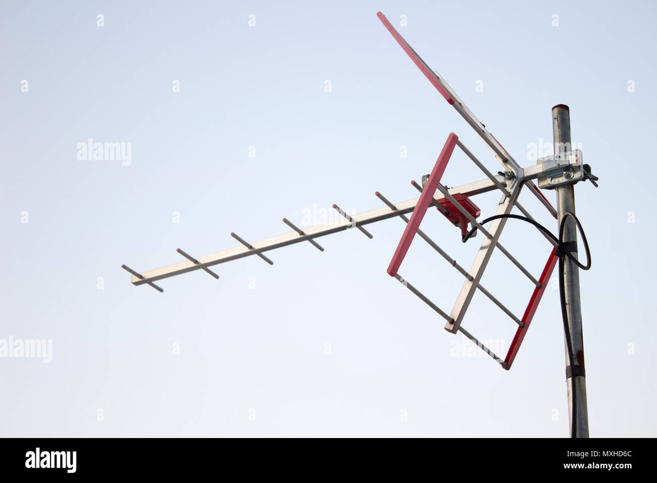 TV antenna pointing to the sky. It's located in the roof of a domestic house. Stock Photo