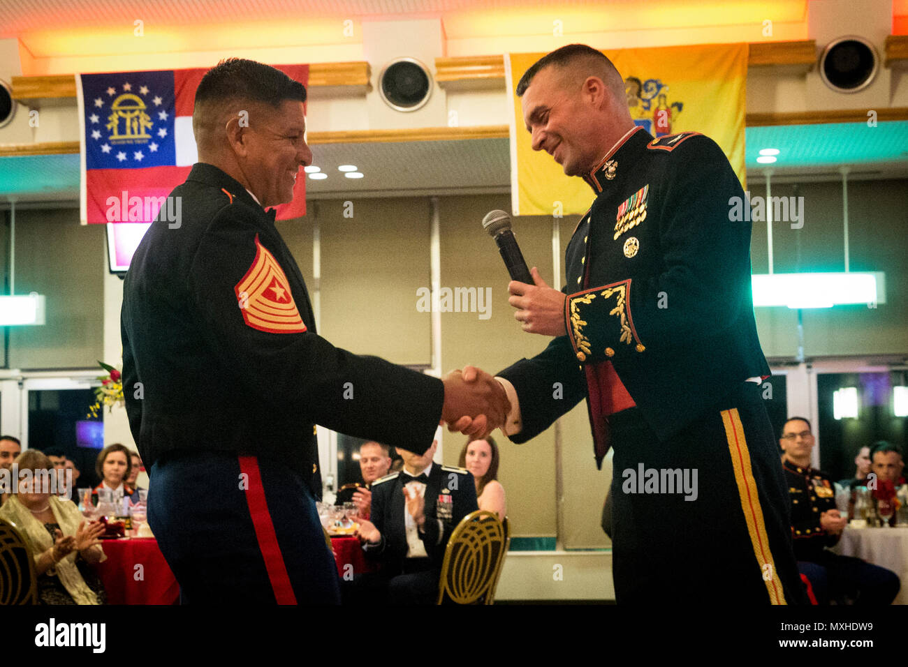 Col. Tye R. Wallace, commander of the 31st Marine Expeditionary Unit, welcomes retired Sgt. Maj. Gonzalo A. “Butch” Vasquez, the guest of honor for the Marine Corps Birthday Ball ceremony at Camp Hansen, Okinawa, Japan, Nov. 11, 2016. The Marines were celebrating the 241st birthday of the U.S. Marine Corps. (U.S. Marine Corps photo by Lance Cpl. Amy Phan, 31st Marine Expeditionary Unit/Released) Stock Photo