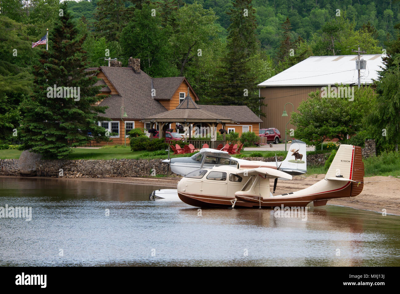 Two seaplanes, a Republic RC-3 and a Cessna 180J tied up on the beach on Lake Pleasant in Speculator, NY in front of the Lake Pleasant Lodge. Stock Photo