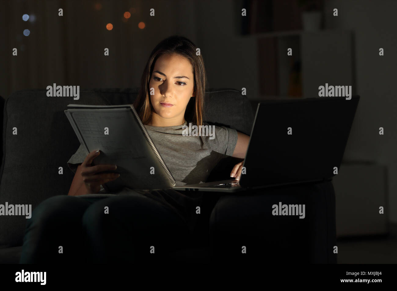 Studious student studying online late hours in the night at home Stock Photo