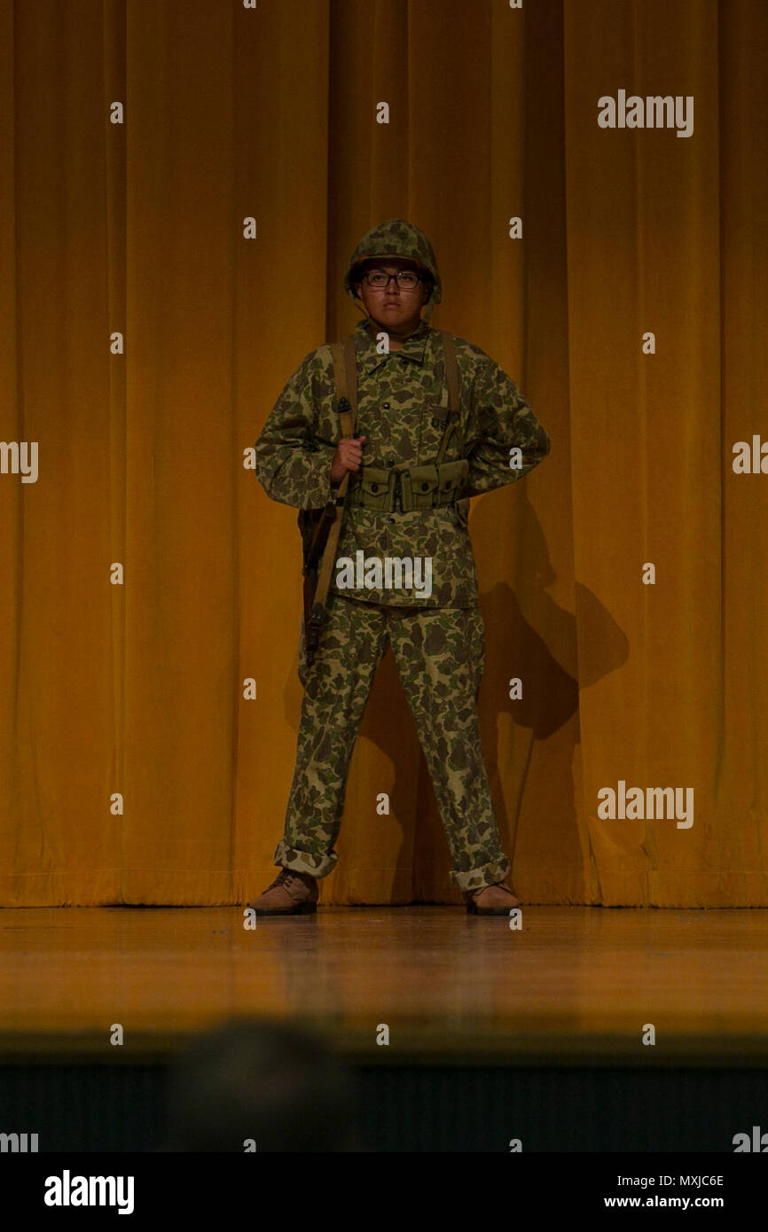 A Kubasaki High School Junior Reserve Officer Training Corps cadet models the uniform worn by the Marines who fought in the World War II during a Marine Corps birthday uniform pageant Nov. 8 aboard Camp Foster, Okinawa, Japan. Marines fought valiantly throughout the Pacific from defense of Wake Island to the Jungle of Guadalcanal. Marines such as Gunnery Sgt. John Basilone and Master Gunnery Sgt. Lou Diamond displayed a courageous fighting spirit that made uncommon valor a common virtue throughout the war. (U.S. Marine Corps photo by Cpl. Daniel Jean-Paul / Released) Stock Photo
