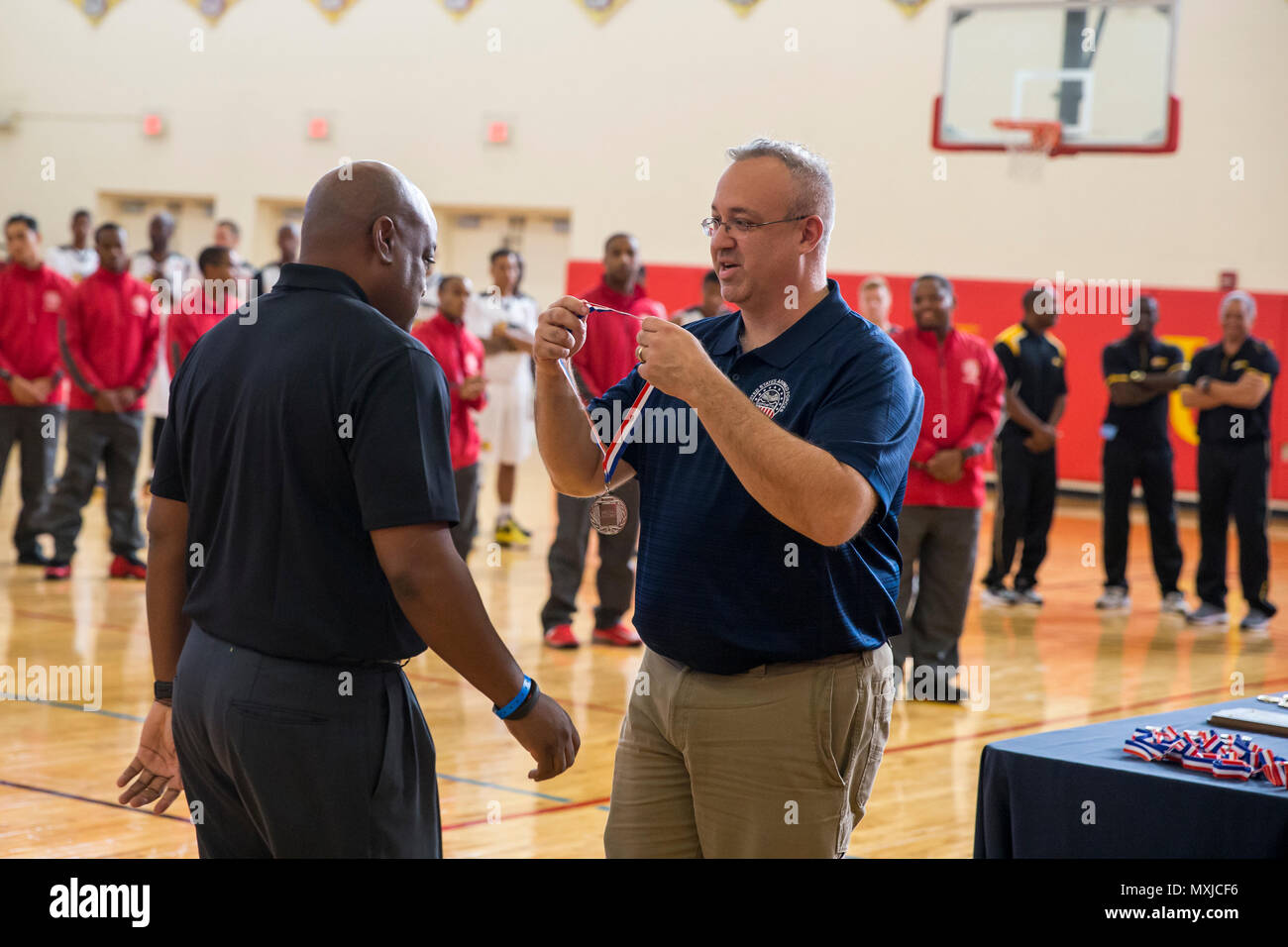 Mr. Steve Dinote, Armed Forces Sports chief of delegation, hands out