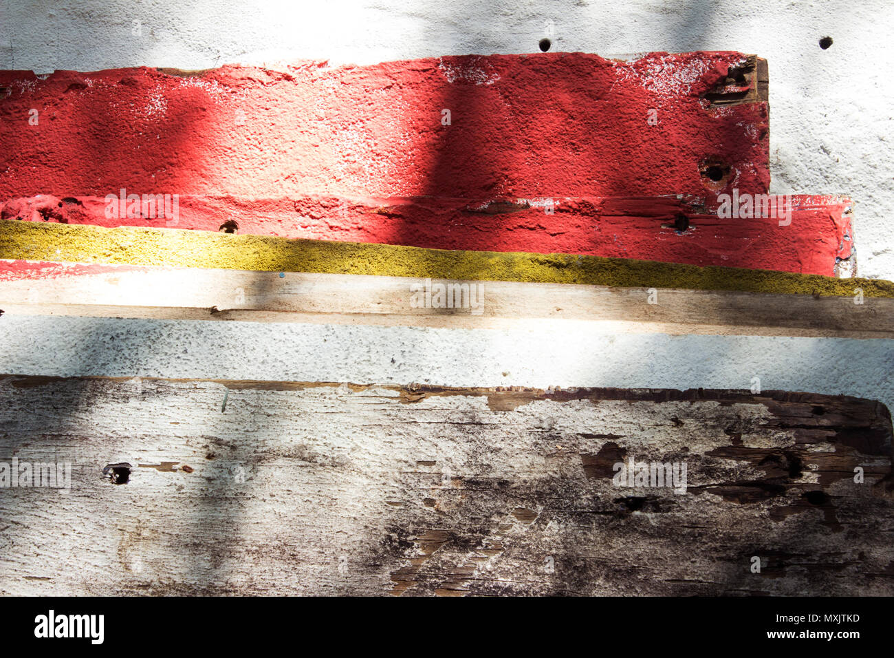 Several plywood sheets of different colors. Screw holes are visible