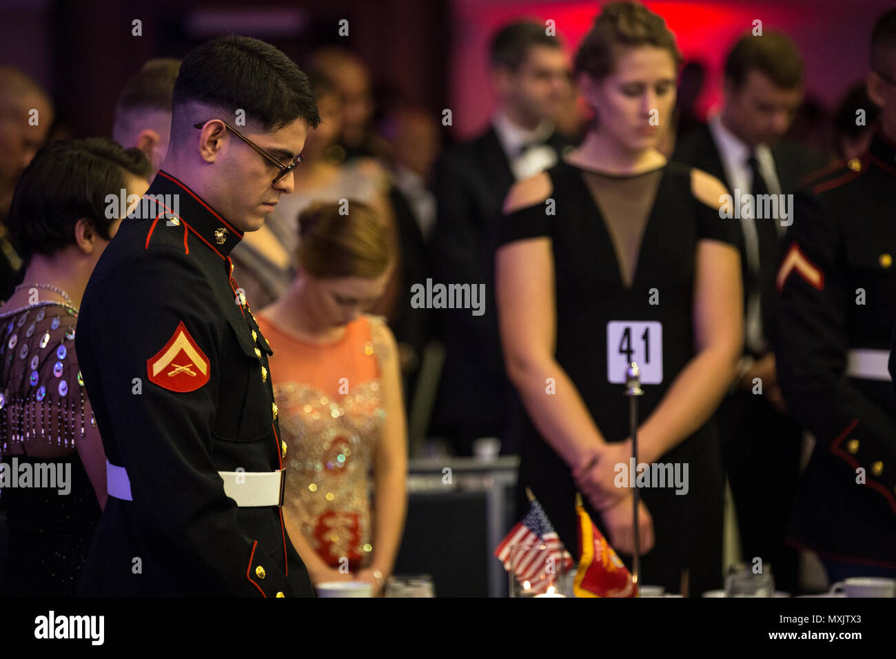 A U.S. Marine bows his head in prayer during the Headquarters & Service Battalion Marine Corps Ball at the Renaissance Arlington Capitol View Hotel, Arlington, Va., Nov. 05, 2016. The ball was held in celebration of the Marine Corps’ 241st birthday. (U.S. Marine Corps photo by Pfc. Alex A. Quiles) Stock Photo