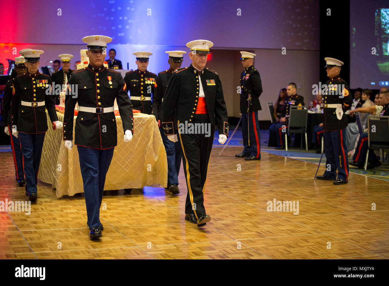 U.S. Marine Corps Chief Warrant Officer 5 Michael W. Edmonson, head of Marine Corps Field Bands, Office of United States Marine Corps Communication, and Pfc. Caleb J. Castaneda, cyber network operator, Administration and Resource Management, march off with the cake detail during the Headquarters & Service Battalion Marine Corps Ball, Renaissance Arlington Capitol View Hotel, Arlington, Va., Nov. 05, 2016. Edmonson and Castenda were recognized as the oldest and youngest Marines present during the celebration of the Marine Corps’ 241st birthday. (U.S. Marine Corps photo by Pfc. Alex A. Quiles) Stock Photo